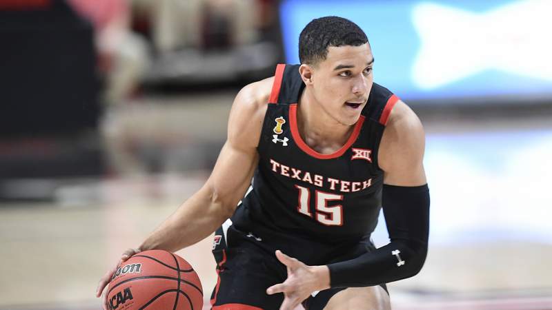 Texas Tech's Kevin McCullar (15) controls the ball during the first half of an NCAA college basketball game against Baylor in Lubbock, Texas, Saturday, Jan. 16, 2021. (AP Photo/Justin Rex)