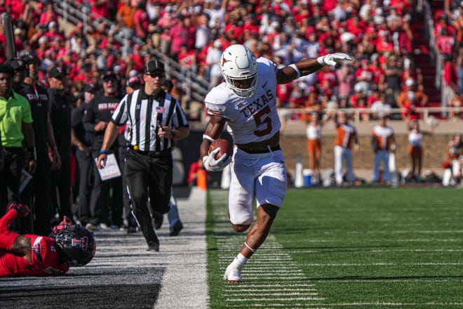 Texas running back Bijan Robinson tries to stay inbounds on a sideline run during Saturday's 37-34 overtime loss to Texas Tech at Jones AT&T Stadium in Lubbock. The loss dropped the Longhorns to 2-2.
