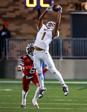 Hutto wide receiver Alex Green makes a leaping grab in front of a Weiss defender during their Nov. 2 game at The Pfield. Green is the receiving end of the most prolific passing-receiving combination in the state this year.