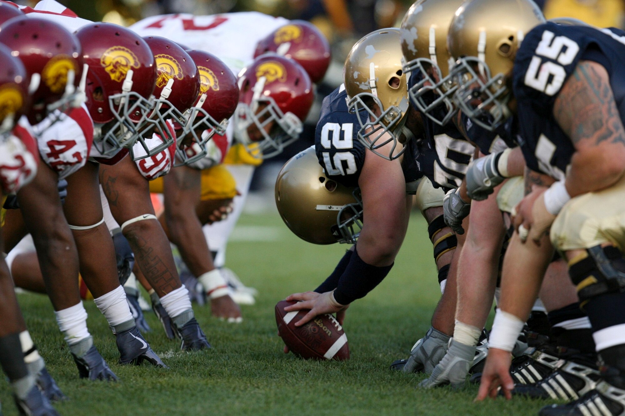 USC and Notre Dame football players line up for a play.